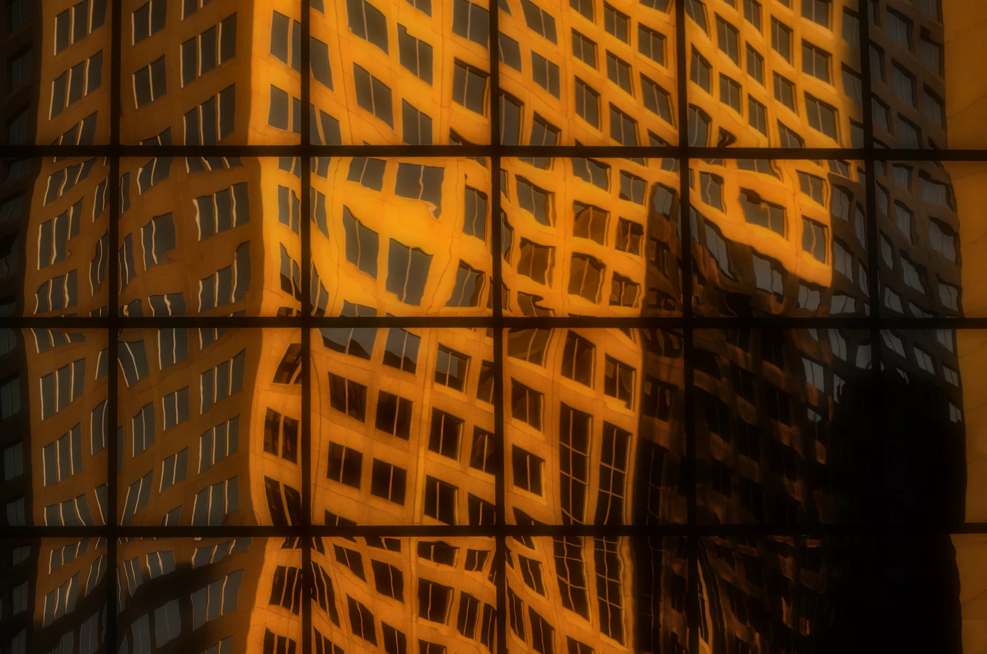 Golden reflections of architecture in a glass facade