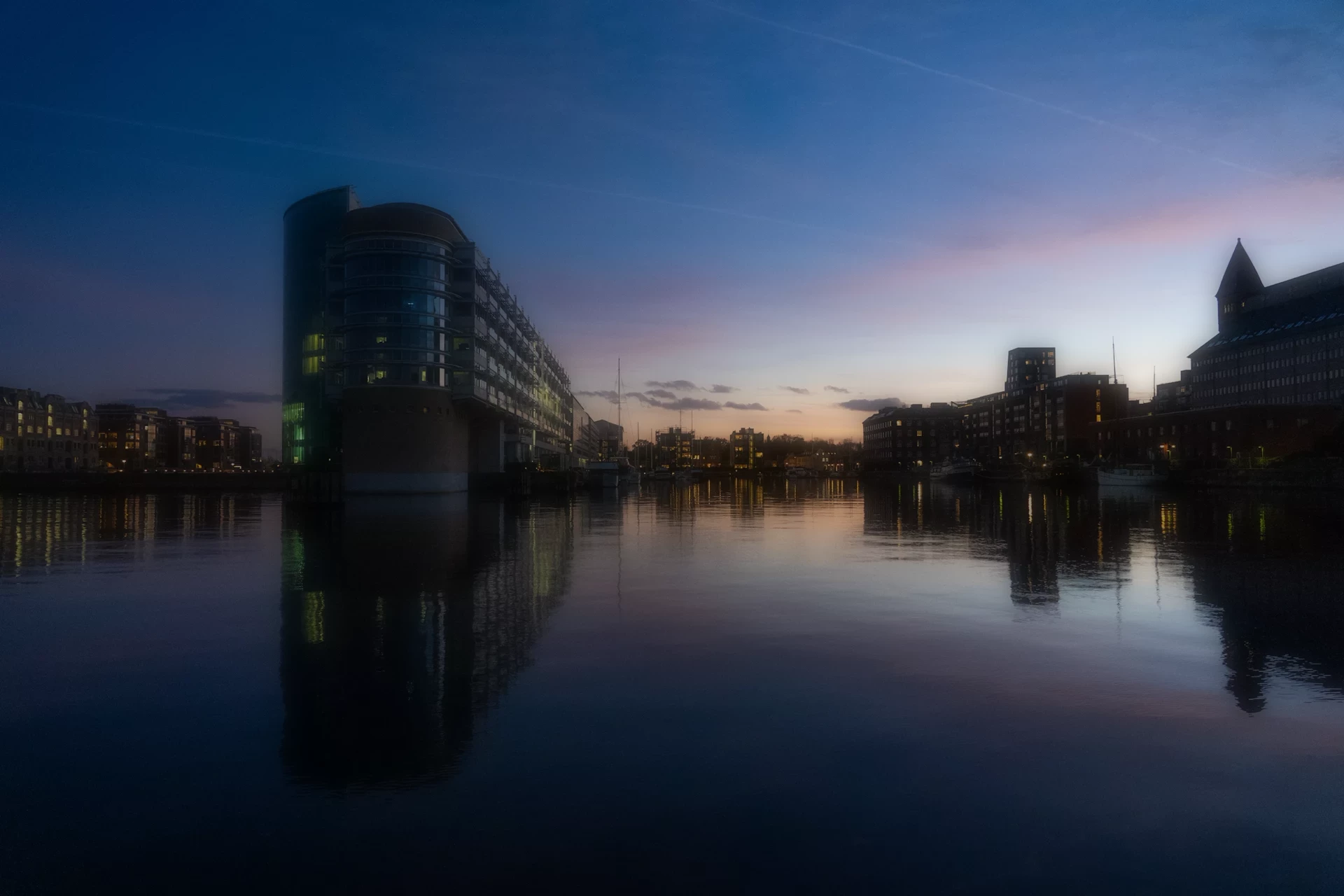 Buildings and evening light reflected in Copenhagen’s quiet harbor